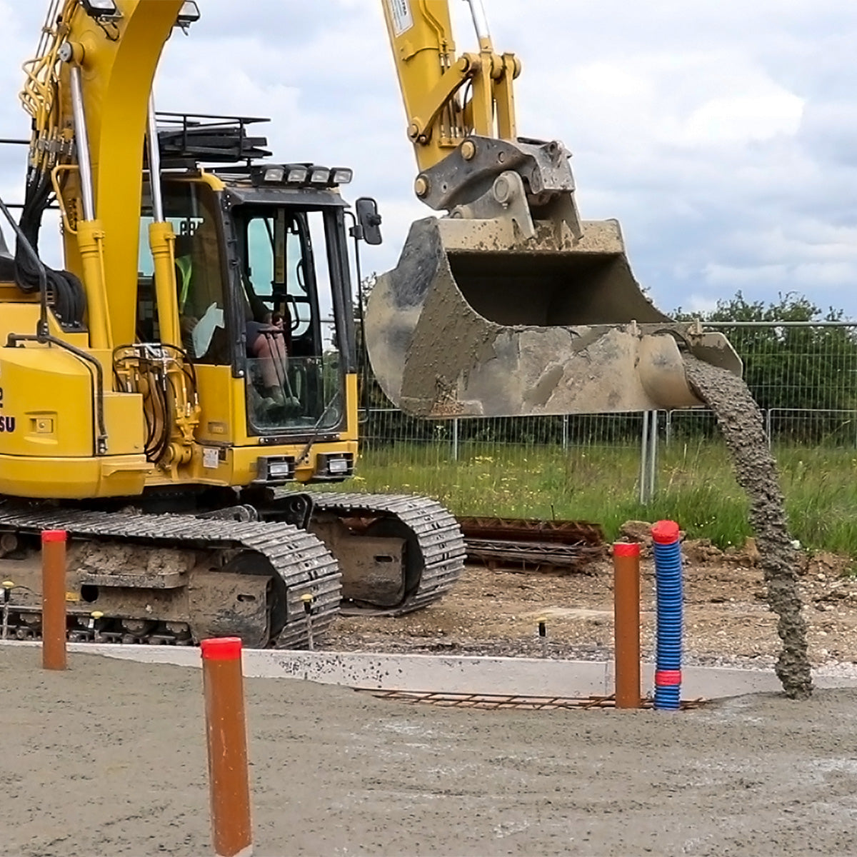 Komatsu PC210LCi-11 Concrete Pouring Bucket pouring around pre-laid pipes
