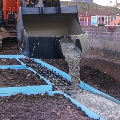 Komatsu PC210LCi-11 Concrete Pouring Bucket pouring into foundation trench